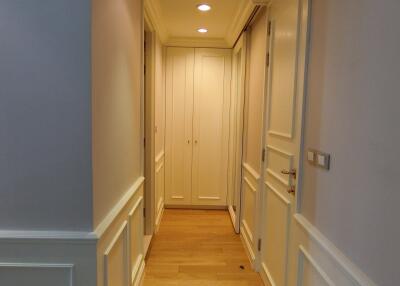 Bright hallway with wooden flooring and decorative wall panels