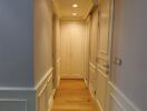 Bright hallway with wooden flooring and decorative wall panels