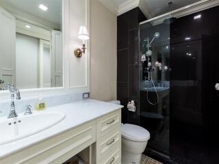 Modern bathroom with glass shower enclosure and white vanity