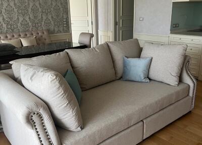 Spacious living room with a chandelier and a large sofa