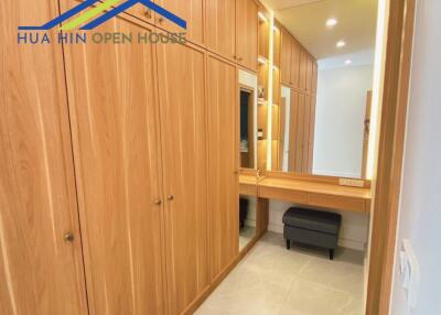 Spacious walk-in closet with wooden cabinetry