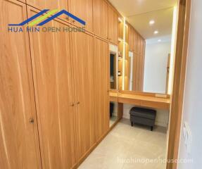 Spacious walk-in closet with wooden cabinetry