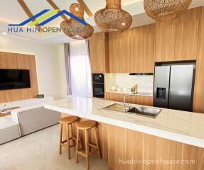 Modern kitchen with wooden cabinets and marble countertop