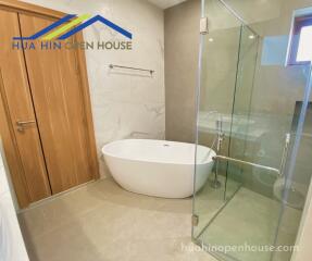 Modern bathroom with a bathtub and glass shower