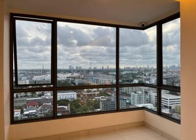 room with large windows offering a panoramic city view