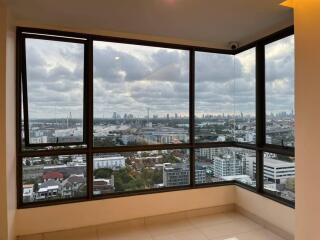 room with large windows offering a panoramic city view