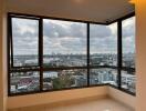 room with large windows offering a panoramic city view