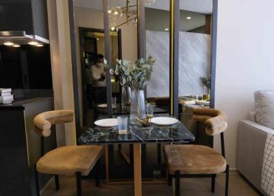 Contemporary dining area with a modern chandelier