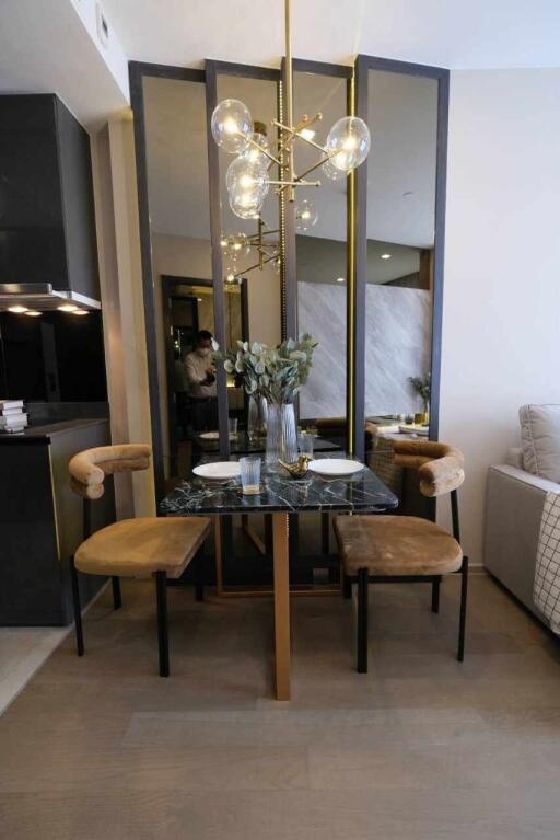 Contemporary dining area with a modern chandelier