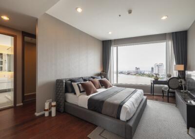 Modern bedroom with a large window overlooking a cityscape