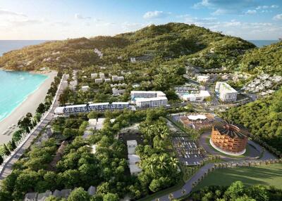 aerial view of a coastal property development surrounded by greenery and ocean