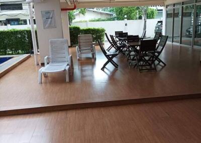 Covered communal seating area with tables and chairs