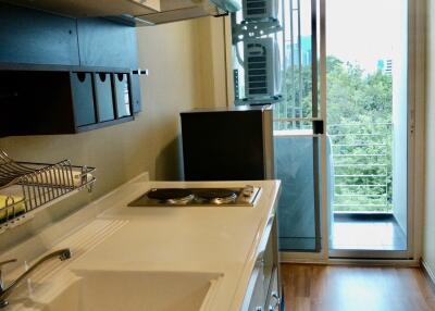 Modern kitchen with large sink and stove, overlooking balcony