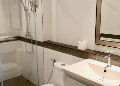 Modern bathroom with a glass shower enclosure and a vanity with a sink