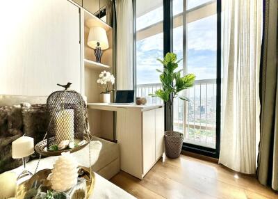 Bright bedroom with a balcony view, desk and decorative items