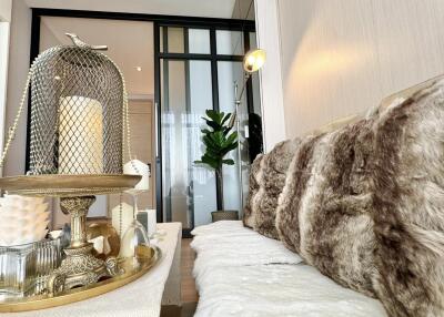 Modern living room with decorative tray, fur cushions, and plant