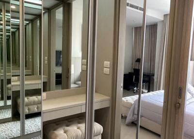 Modern bedroom with mirrored wardrobe and dressing area