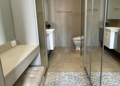 Bathroom with mirrored walls and modern fixtures