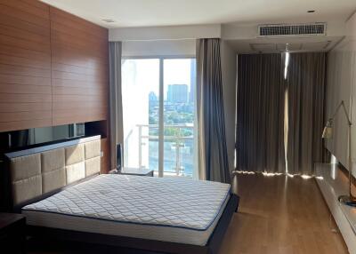 Spacious bedroom with large window and city view