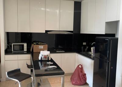 Modern kitchen with black and white cabinets and appliances