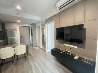 Living room with wall-mounted TV and modern furniture