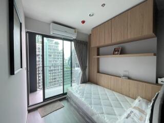 Modern bedroom with a balcony and city view