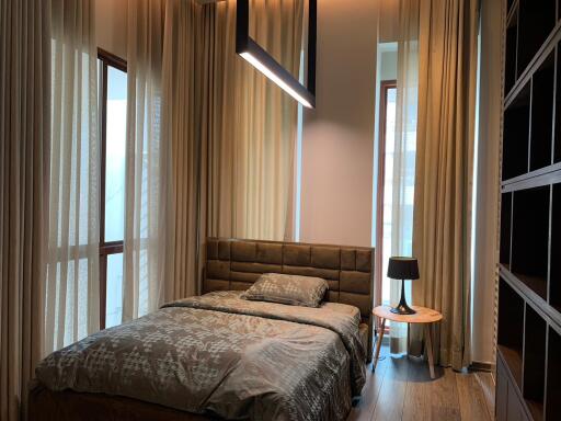 Modern bedroom with large windows and a double bed