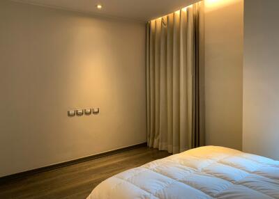 Modern minimalist bedroom with cozy lighting and thick curtains