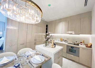 Modern kitchen with dining table and chandelier