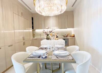 Modern dining area with elegant furnishings and chandelier