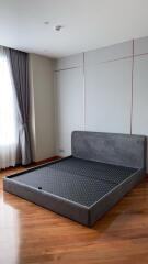 unfurnished bedroom with bed frame and wooden flooring