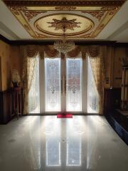 Elegant living room with ornate decor and large glass doors