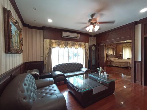 Spacious living room with elegant wooden finishes and comfortable seating