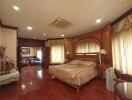 Spacious bedroom with wooden floors and elegant decor