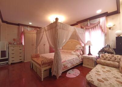 Elegant and spacious bedroom with canopy bed and plush decor