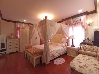 Elegant and spacious bedroom with canopy bed and plush decor