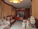 Elegantly furnished living room with floral sofas and chandelier