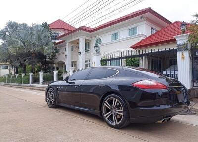 Exterior view of a house with a black car in the driveway