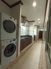 Laundry area with stacked washer and dryer