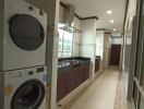 Laundry area with stacked washer and dryer