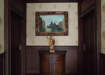 Elegant hallway with artwork and statue