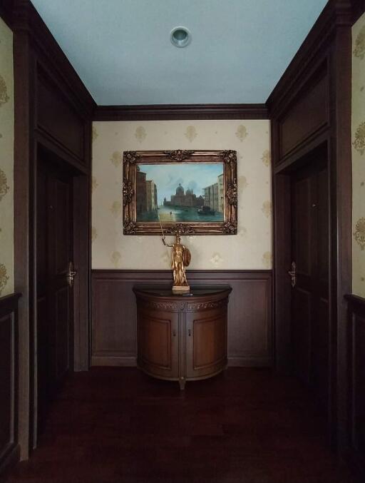 Elegant hallway with artwork and statue