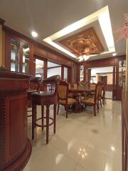 Luxurious dining area with ornate ceiling and wooden furniture