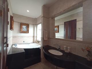 Spacious bathroom with a bathtub and a sink