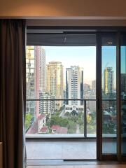 View from an apartment balcony showcasing a city skyline with multiple high-rise buildings.