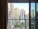 View from an apartment balcony showcasing a city skyline with multiple high-rise buildings.