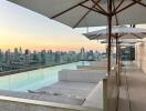 A rooftop pool area with umbrellas and an expansive city view