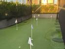 Outdoor mini golf area with artificial turf and flags