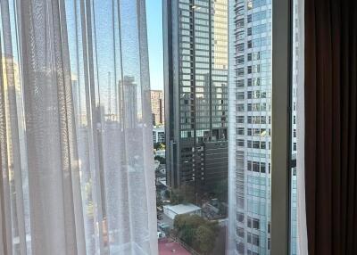 View from the living room showing cityscape through large window