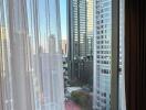 View from the living room showing cityscape through large window